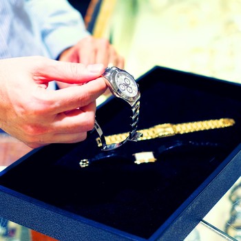 Man holding watch at Gray & Sons