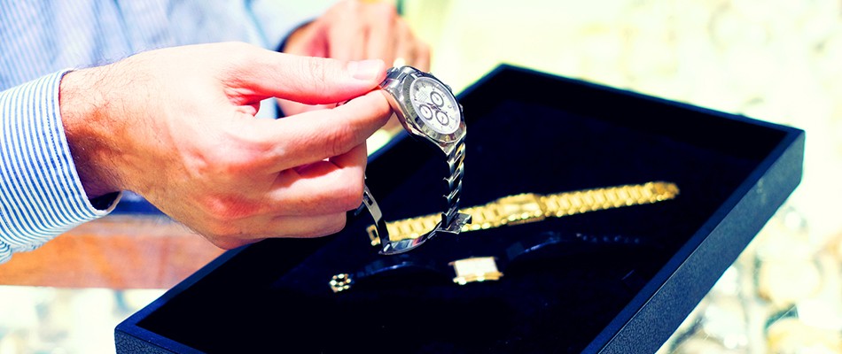 Man holding watch at Gray & Sons