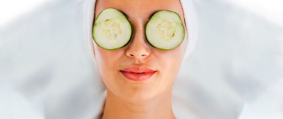 Woman with cucumbers over eyes