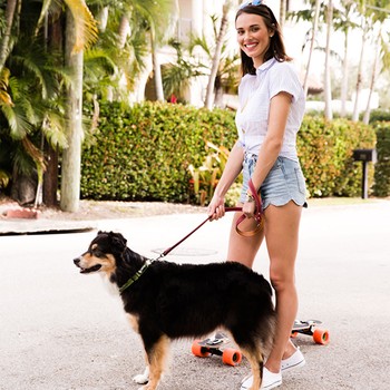 Lady holding dog on leash